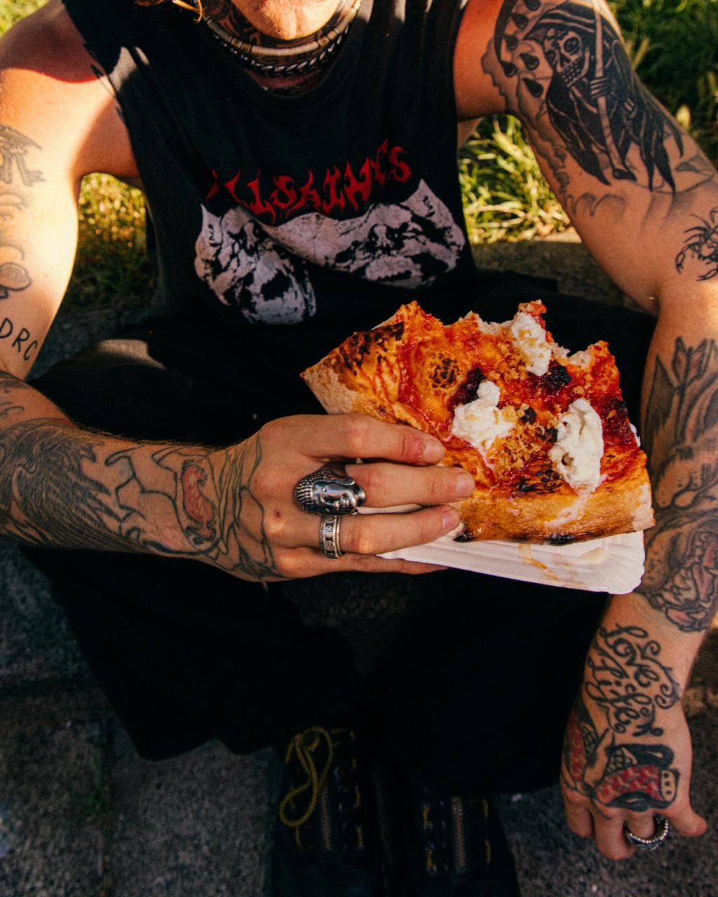 A NO FLOP pizza slice, blistered crust and dollops of burrata
